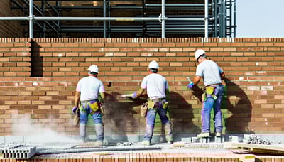 Skilled masons working on a brick wall in Fort Worth, Texas